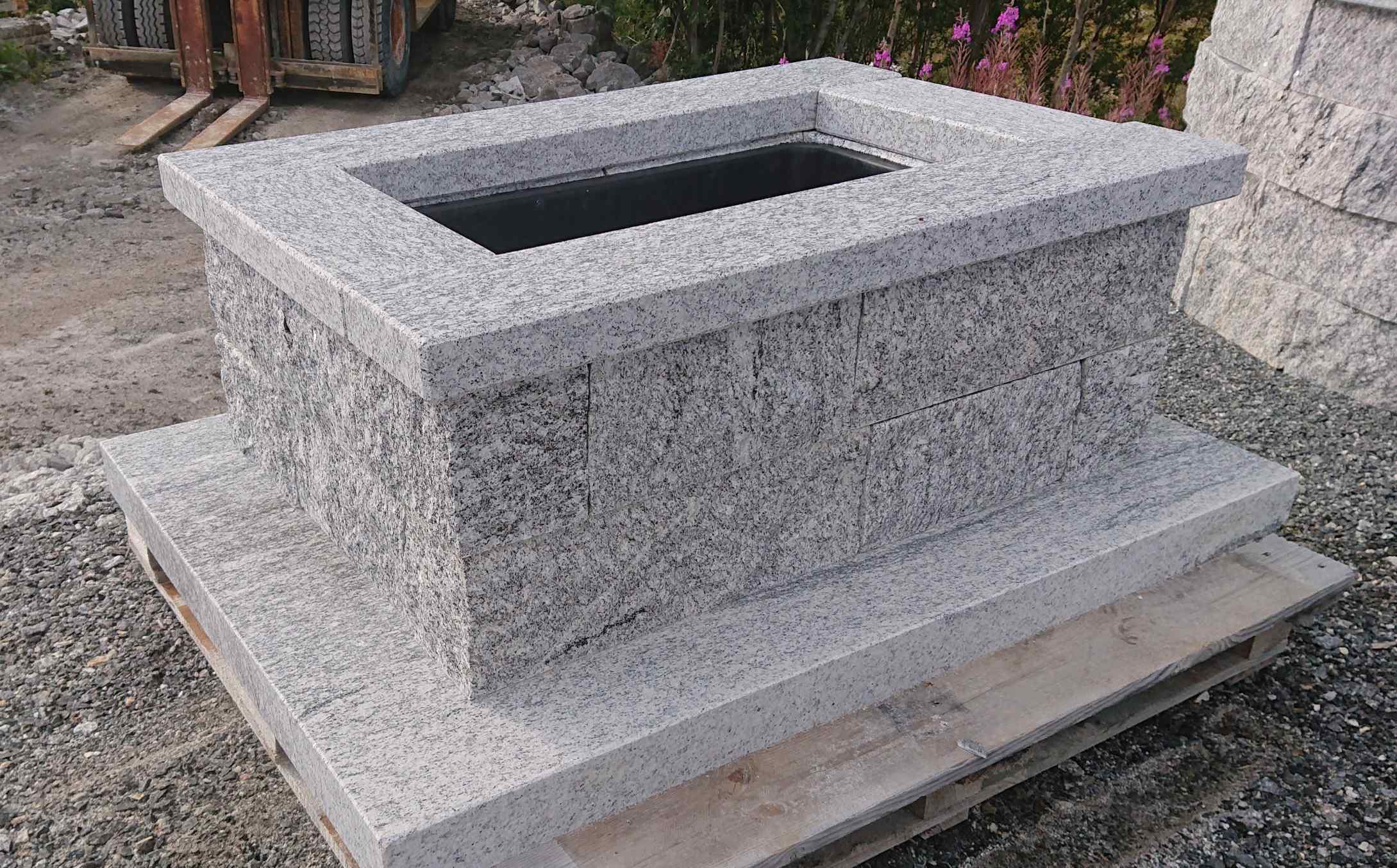 Benk av granitt med trekasse